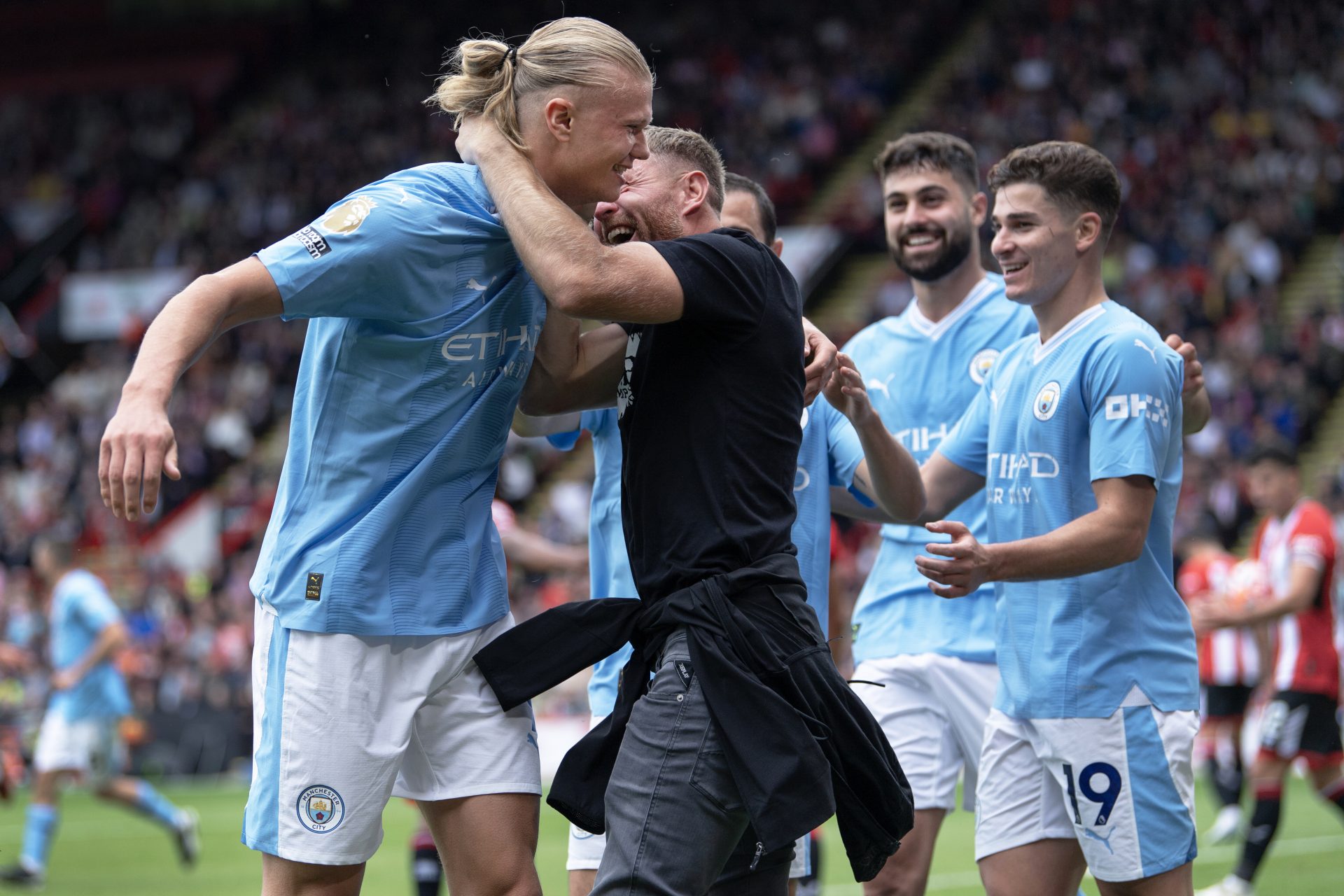 Erling Haaland mobbed by world champion pitch invader