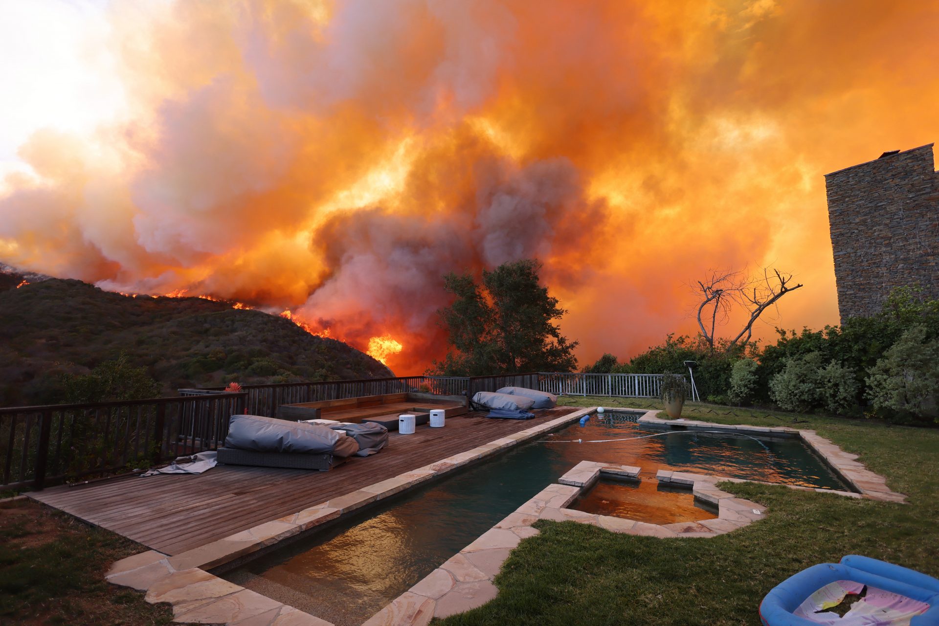 Wildfires savage three Los Angeles suburbs with thousands fleeing their homes